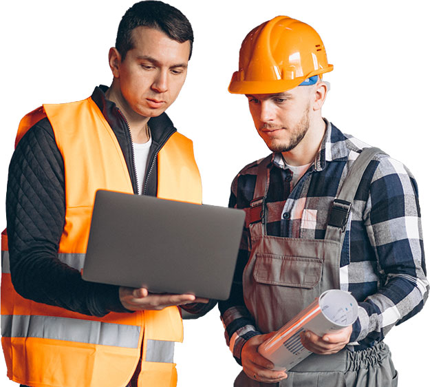 A foreman and construction worker in a factory looking at a laptop